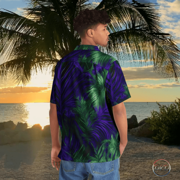 Model wearing purple and green palm frond Hawaiian shirt. The setting is a Hawaiian beach sunset.