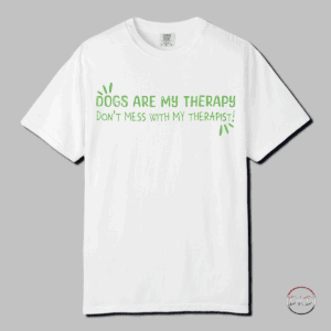 Cozy up to comfort in this Comfort Colors 1717 Therapy Dog T-shirt with Green Playful Text. This t-shirt features playful green text that reads: 'DOGS ARE MY THERAPY DON'T MESS WITH MY THERAPIST'. The relaxed fit keeps the wearer comfy in both casual and semi-formal settings, while the crew neckline delivers a classic, neat style. Perfect for those who are dog lovers and find comfort and emotional support in their furry friends. Ideal for dog owners, therapists, and anyone who enjoys a good sense of humor. Relevant for dog lovers, mental health advocates, therapists, and pet owners. Great for casual wear, therapists' office wear, dog walking, and National Dog Day celebrations.
