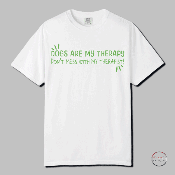 Cozy up to comfort in this Comfort Colors 1717 Therapy Dog T-shirt with Green Playful Text. This t-shirt features playful green text that reads: 'DOGS ARE MY THERAPY DON'T MESS WITH MY THERAPIST'. The relaxed fit keeps the wearer comfy in both casual and semi-formal settings, while the crew neckline delivers a classic, neat style. Perfect for those who are dog lovers and find comfort and emotional support in their furry friends. Ideal for dog owners, therapists, and anyone who enjoys a good sense of humor. Relevant for dog lovers, mental health advocates, therapists, and pet owners. Great for casual wear, therapists' office wear, dog walking, and National Dog Day celebrations.