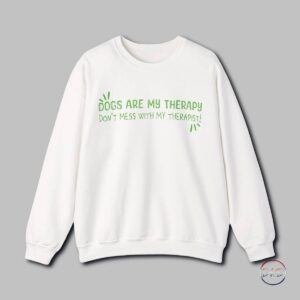 A cozy Gildan sweatshirt featuring a playful text design that reads 'Dogs Are My Therapy - Don't Mess With My Therapist'. This sweatshirt is perfect for dog lovers who find comfort and joy in the presence of their furry friends. It is ideal for casual wear during colder months, providing both warmth and style. Great for dog lovers, pet owners, and anyone who values the therapeutic effects of spending time with their pets. Relevant for holidays like National Dog Day and occasions celebrating the bond between humans and dogs.