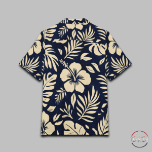 This Hawaiian Button-Down Shirt features cream on navy tropical florals—stylized hibiscus blooms, monstera leaves, palm fronds, and delicate ferns. It exudes a classic island vibe with a soft, elegant twist, perfect for casual settings or beach days. Ideal for those who love tropical themes, this shirt is great for vacations, luaus, summer parties, and beach outings.