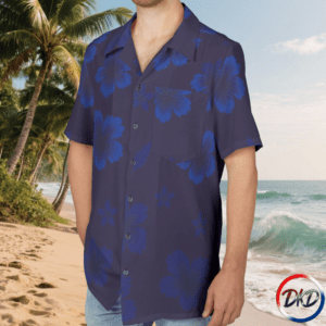 Model wearing shirt front-Elevate your summer style with Blue Ember Bloom, a unisex Hawaiian shirt designed for bold, tropical expression. Featuring oversized blue hibiscus flowers against a deep purple background, this vibrant button‑up delivers standout island energy in a lightweight, breathable fabric. Perfect for vacations, beachwear, resort outfits, and everyday casual looks, this tropical floral shirt brings comfort and color to any warm‑weather wardrobe.