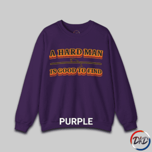 A Purple unisex fit crewneck sweatshirt featuring bold retro orange‑and‑brown typography that reads “A Hard Man Is Good to Find,” with a vintage curved accent line and star between the text lines.
