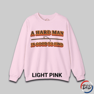 A Light Pink unisex fit crewneck sweatshirt featuring bold retro orange‑and‑brown typography that reads “A Hard Man Is Good to Find,” with a vintage curved accent line and star between the text lines.