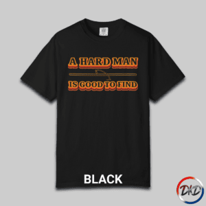 A black Comfort Colors® 1717 T‑shirt featuring bold retro orange-and-black typography that reads “A Hard Man Is Good to Find,” with a small vintage accent graphic between the lines.