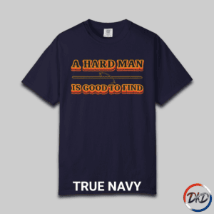 A True Navy Comfort Colors® 1717 T‑shirt featuring bold retro orange-and-black typography that reads “A Hard Man Is Good to Find,” with a small vintage accent graphic between the lines.